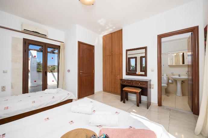 Bedroom with double bed, single bed, en suite bathroom, and A/C . - Villa Nikolas . (Photo Gallery) }}