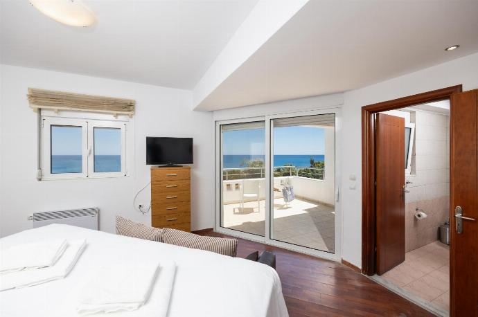 Main building: double bedroom with en suite bathroom, sofa, A/C, TV, and sea views . - Villa Pelagos Blue . (Photo Gallery) }}