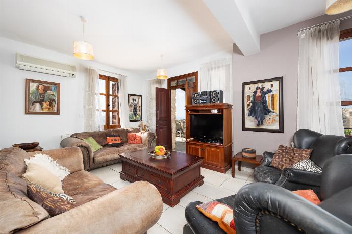 Open-plan living room with sofas, dining area, kitchen, ornamental fireplace, A/C, WiFi internet, and satellite TV . - Villa Irene Palace . (Galleria fotografica) }}