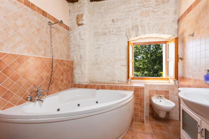 En suite bathroom with bath  . - Villa Damiana . (Photo Gallery) }}