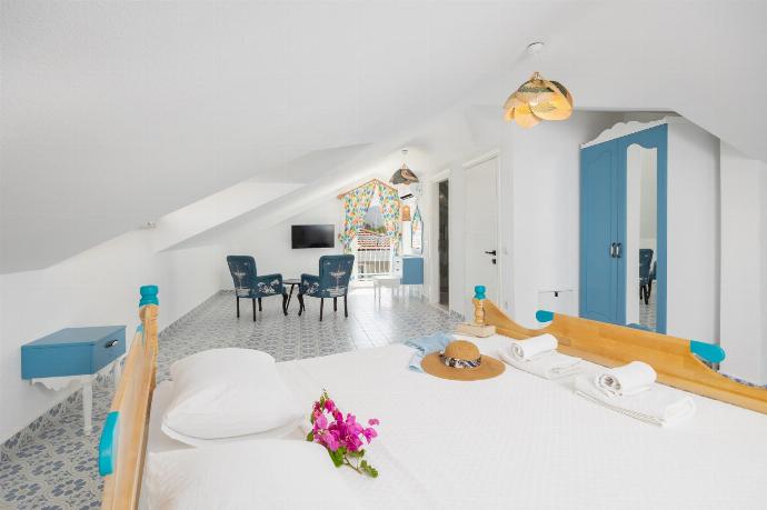 Double bedroom with en suite bathroom, seating, TV, and A/C . - Villa Blue Island . (Photo Gallery) }}