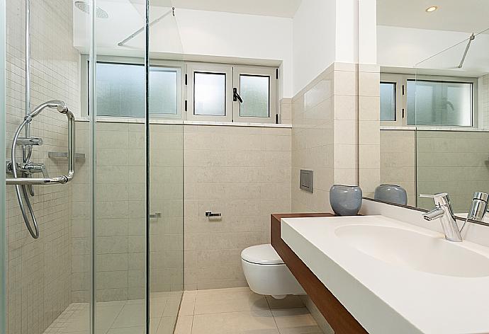 En suite bathroom with shower . - Annabel Beach Palace . (Photo Gallery) }}