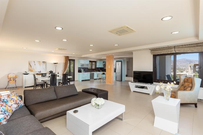 Open-plan living room with sofas, dining area, kitchen, A/C, WiFi internet, satellite TV, and panoramic sea views . - Villa Panorama . (Photo Gallery) }}