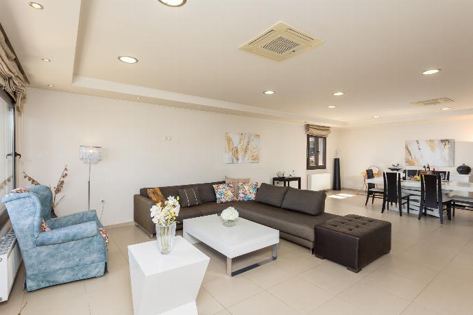 Open-plan living room with sofas, dining area, kitchen, A/C, WiFi internet, satellite TV, and panoramic sea views . - Villa Panorama . (Photo Gallery) }}