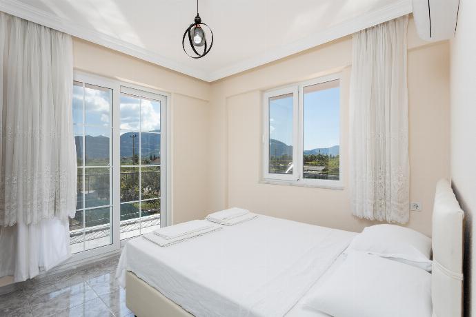Double bedroom with A/C and balcony access . - Villa Corals . (Photo Gallery) }}