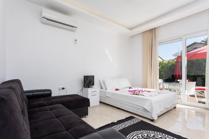 Double bedroom with A/C, kitchenette, sofa, and TV . - Villa Casa Mia . (Photo Gallery) }}