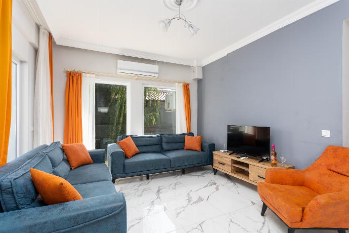 Open-plan living room with sofas, kitchen, A/C, WiFi internet, and satellite TV . - Villa Mazoya . (Photo Gallery) }}