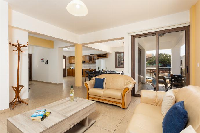 Open-plan living room with sofas, dining area, kitchen, A/C, WiFi internet, satellite TV, and sea views . - Villa Serena . (Photo Gallery) }}