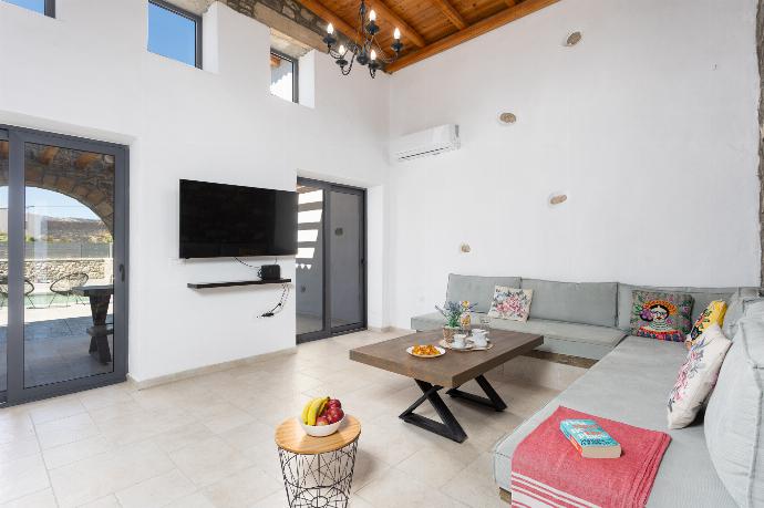 Open-plan living room with sofa, dining area, kitchen, A/C, WiFi internet, and satellite TV . - La Casa Di Pietre 2 . (Photo Gallery) }}