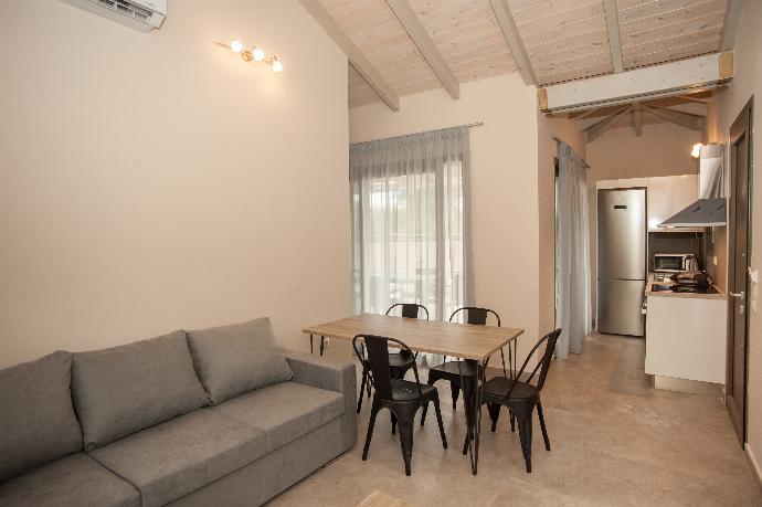 Open plan living room with comfortable sitting, TV, dining area, patio doors . - Villa Gerasmia . (Photo Gallery) }}