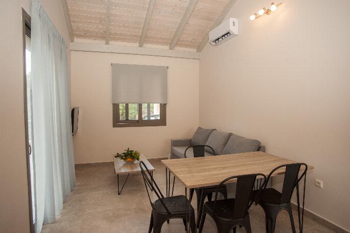 Open plan living room with comfortable sitting, TV, dining area, patio doors . - Villa Gerasmia . (Photo Gallery) }}