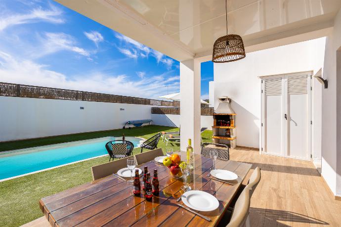 Sheltered terrace area with BBQ . - Villa Cindy . (Photo Gallery) }}