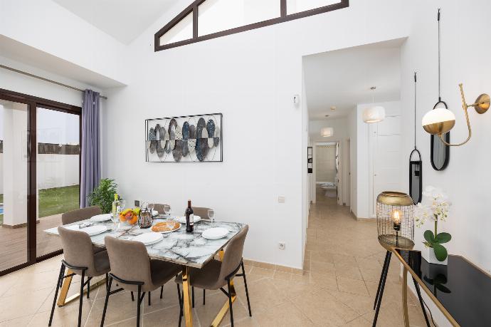 Living room with sofa, dining area, A/C, WiFi internet, and satellite TV . - Villa Cindy . (Galería de imágenes) }}