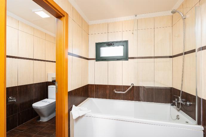 En suite bathroom with bath and shower . - Villa Dacil . (Photo Gallery) }}
