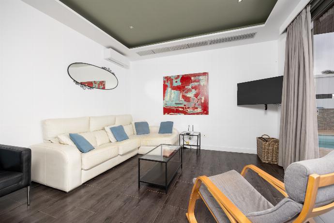 Living room with sofa, dining area, A/C, WiFi internet, and satellite TV . - Villa Sal Marina . (Photo Gallery) }}