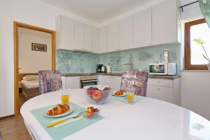 Equipped kitchen with dinning area . - Villa Tereza . (Photo Gallery) }}