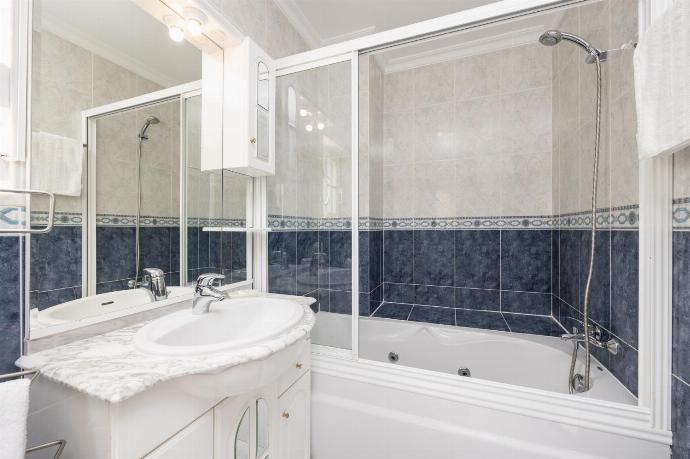 En suite bathroom with bath and shower . - Villa Marlene . (Photo Gallery) }}