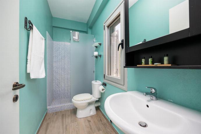 En suite bathroom with shower . - Villa Marmari . (Photo Gallery) }}