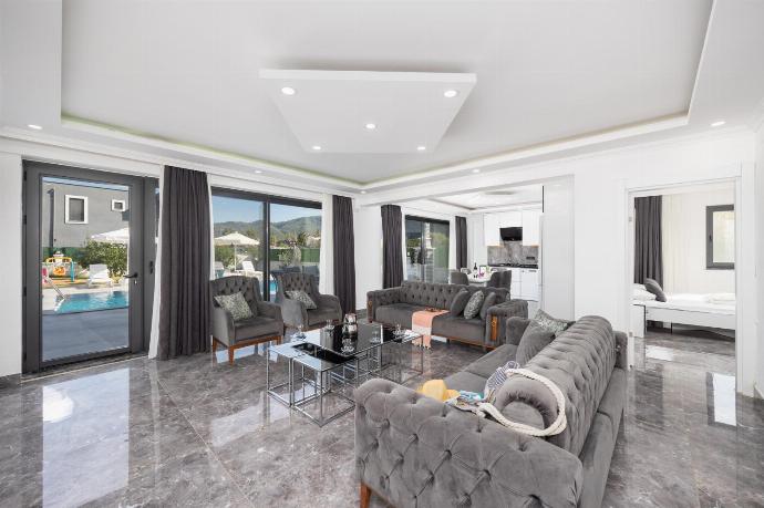 Open-plan living room with sofas, dining area, kitchen, A/C, WiFi internet, and satellite TV . - Villa Grand Yasar 1 . (Photo Gallery) }}