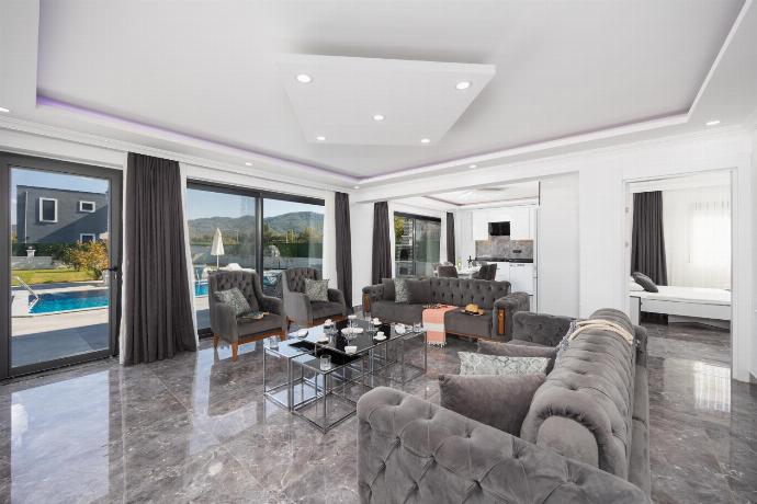 Open-plan living room with sofas, dining area, kitchen, A/C, WiFi internet, and satellite TV . - Villa Grand Yasar 3 . (Photo Gallery) }}