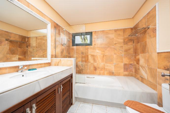 En suite bathroom with bath and shower . - Villa Dragos . (Photo Gallery) }}