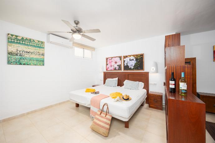 Twin bedroom with en suite bathroom, living area, and A/C . - Villa Dragos . (Photo Gallery) }}