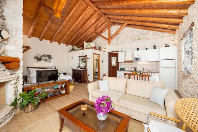 Open-plan villa with sofa, dining area, kitchen, double bed, bathroom, ornamental fireplace, A/C, WiFi internet, satellite TV, and sea views . - Villa Gallini . (Photo Gallery) }}