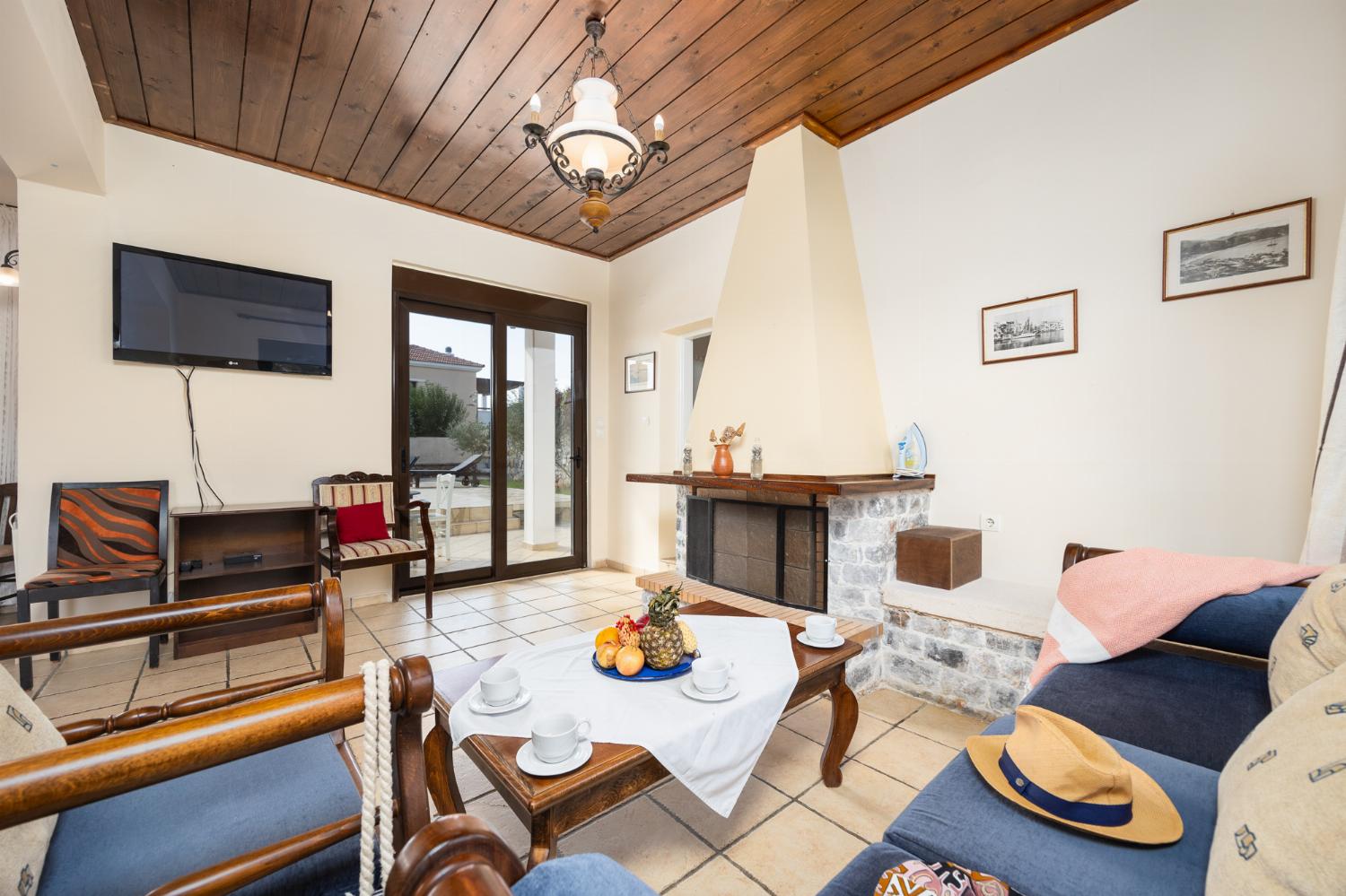 Living room with sofa, ornamental fireplace, WiFi internet, and satellite TV