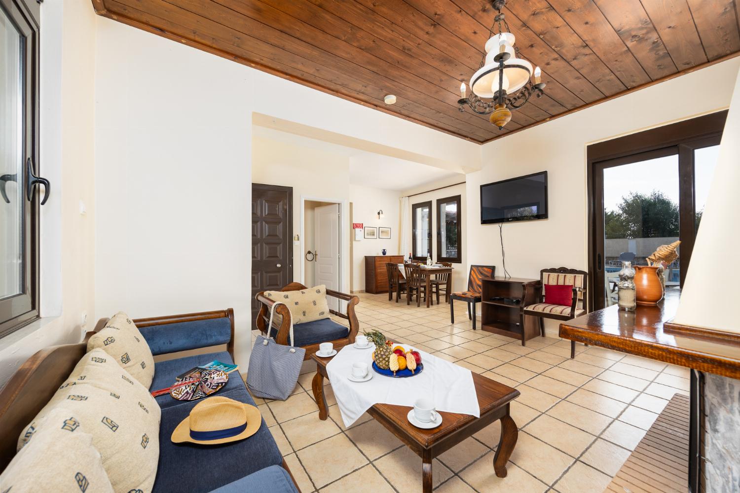 Living room with sofa, ornamental fireplace, WiFi internet, and satellite TV