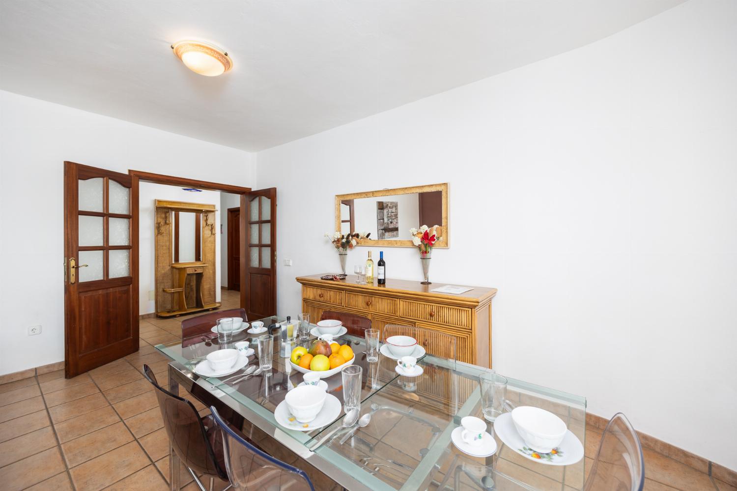 Living room with sofas, dining area, A/C, WiFi internet, and satellite TV