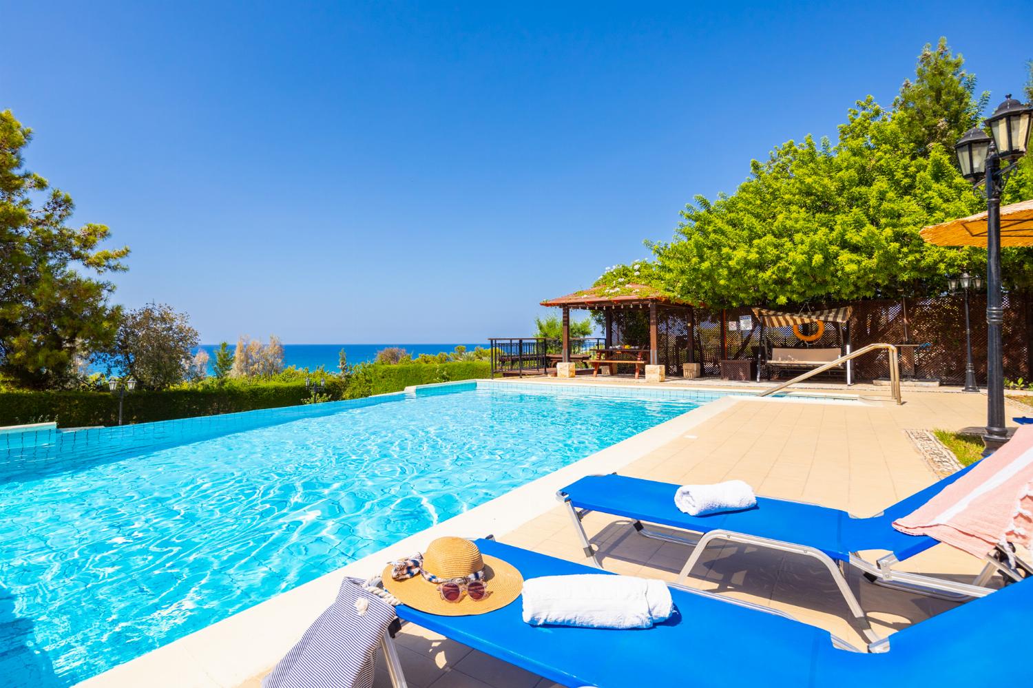 Private pool, terrace, and garden with sea views