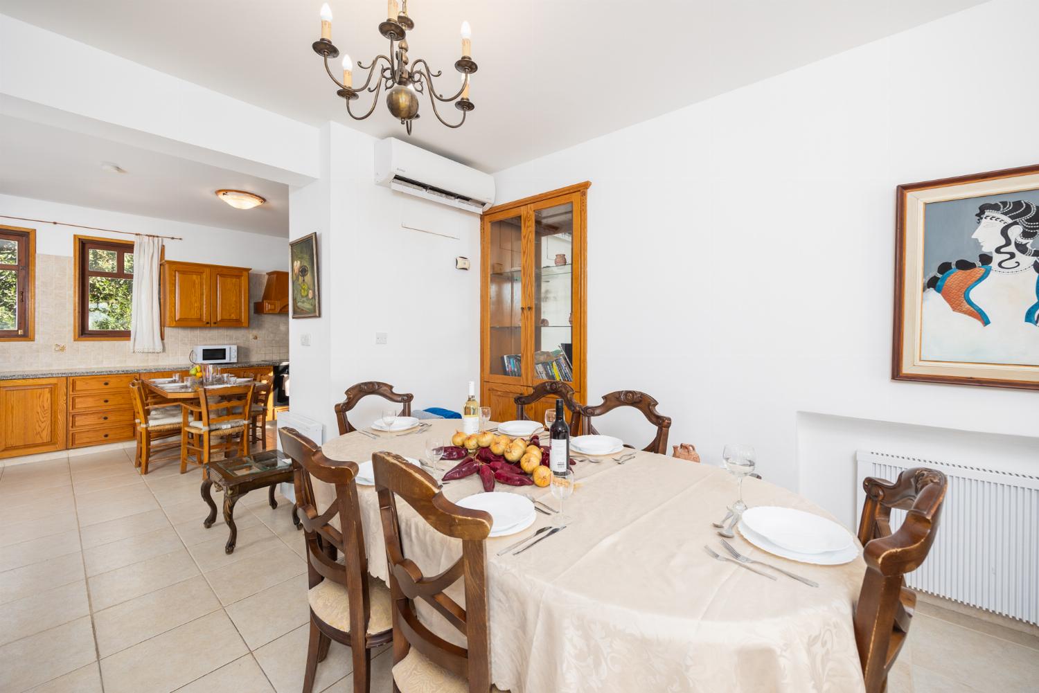 Open-plan living room with sofa, dining area, kitchen, ornamental fireplace, A/C, WiFi internet, satellite TV, and sea views