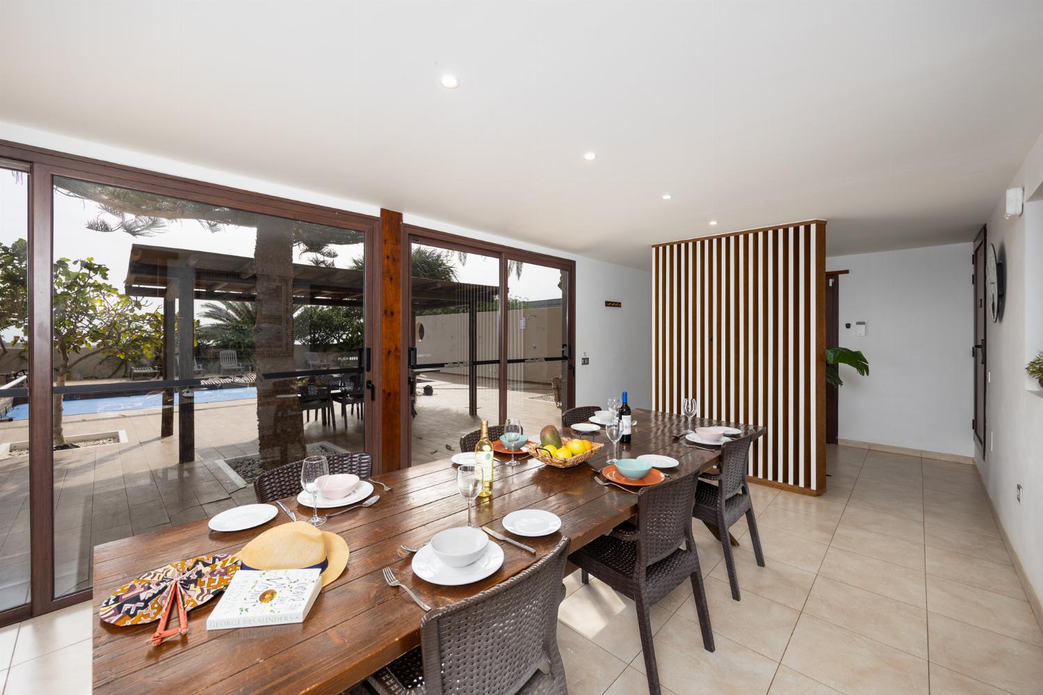 Open-plan living room with sofas, dining area, kitchen, ornamental fireplace, WiFi internet, and satellite TV