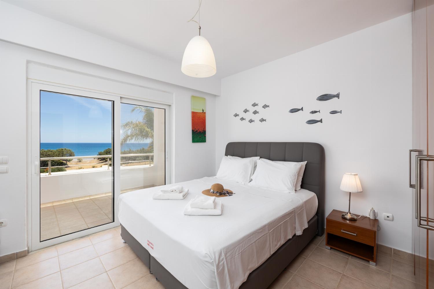 Main building: double bedroom with A/C, TV, and sea views