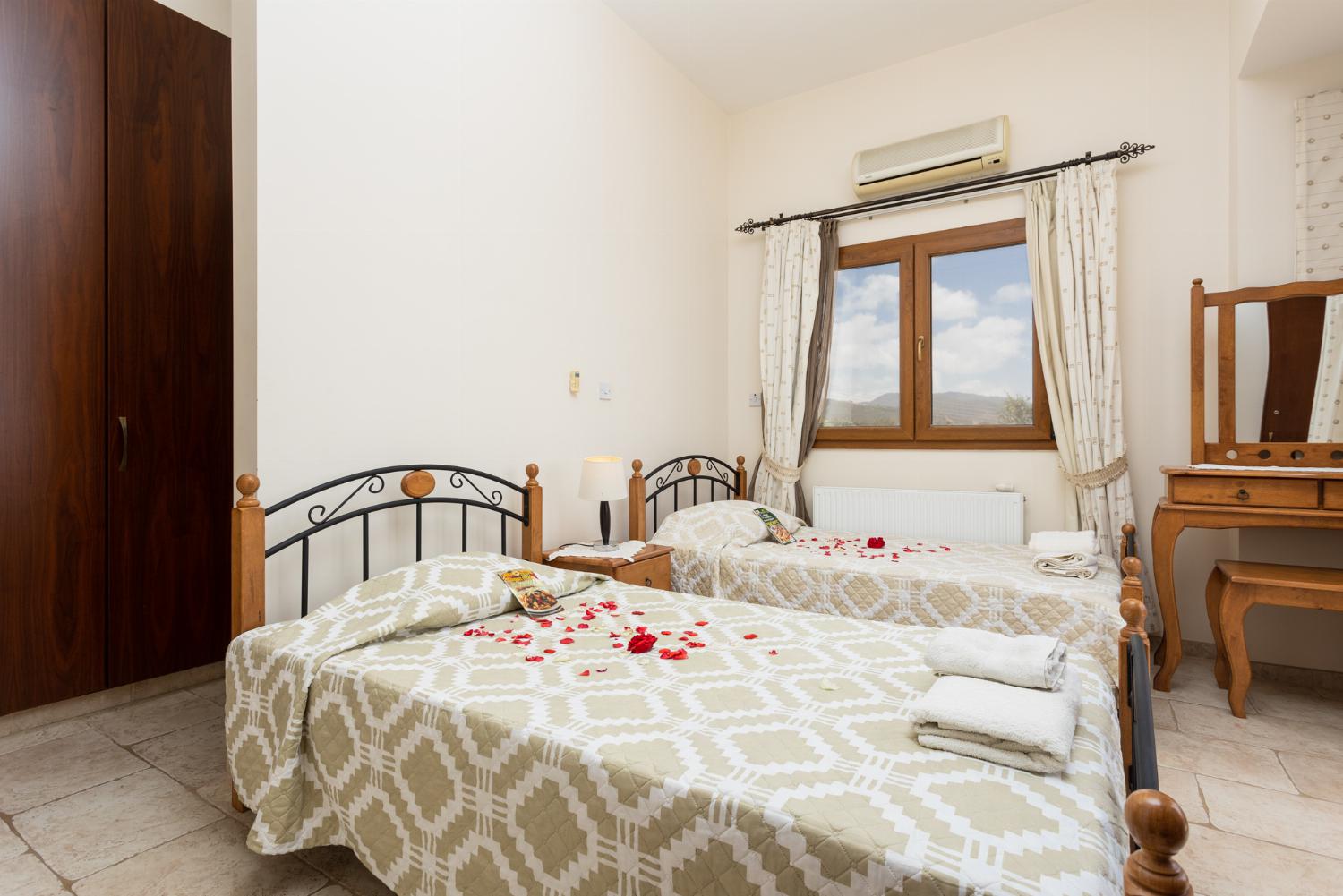 Twin bedroom on first floor with en suite bathroom, A/C, sea views, and balcony access