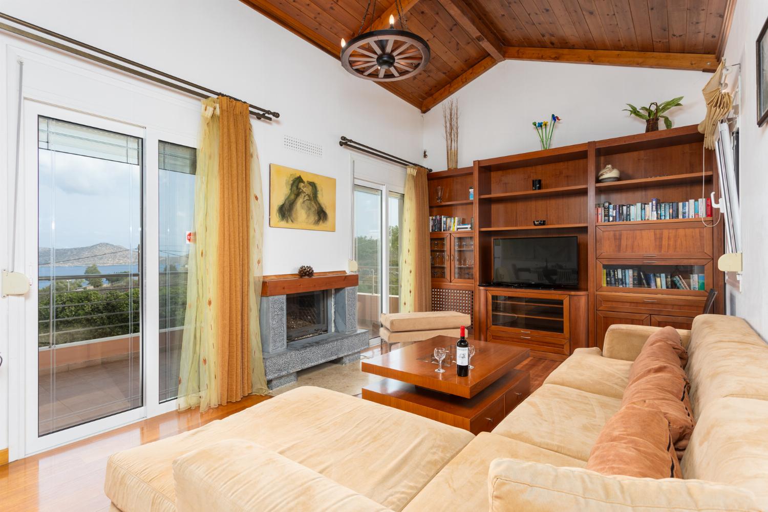 Open-plan living room with sofa, dining area, kitchen, A/C, WiFi internet, satellite TV, and sea views