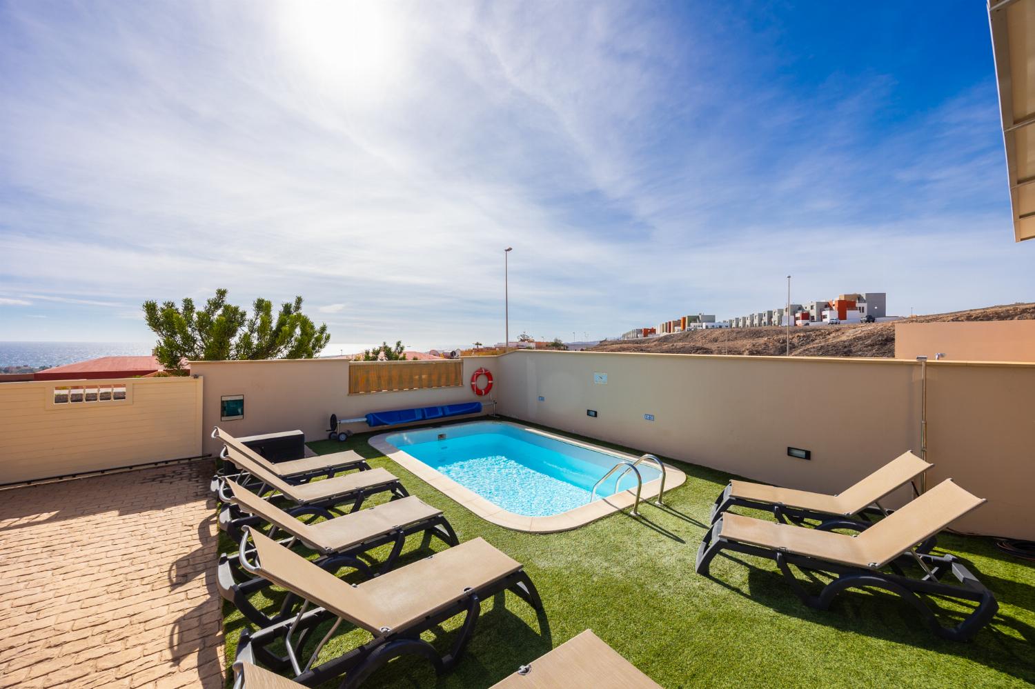 Pool and terrace with sea views