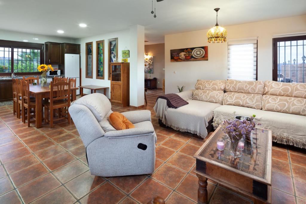 Open-plan living room with sofas, dining area