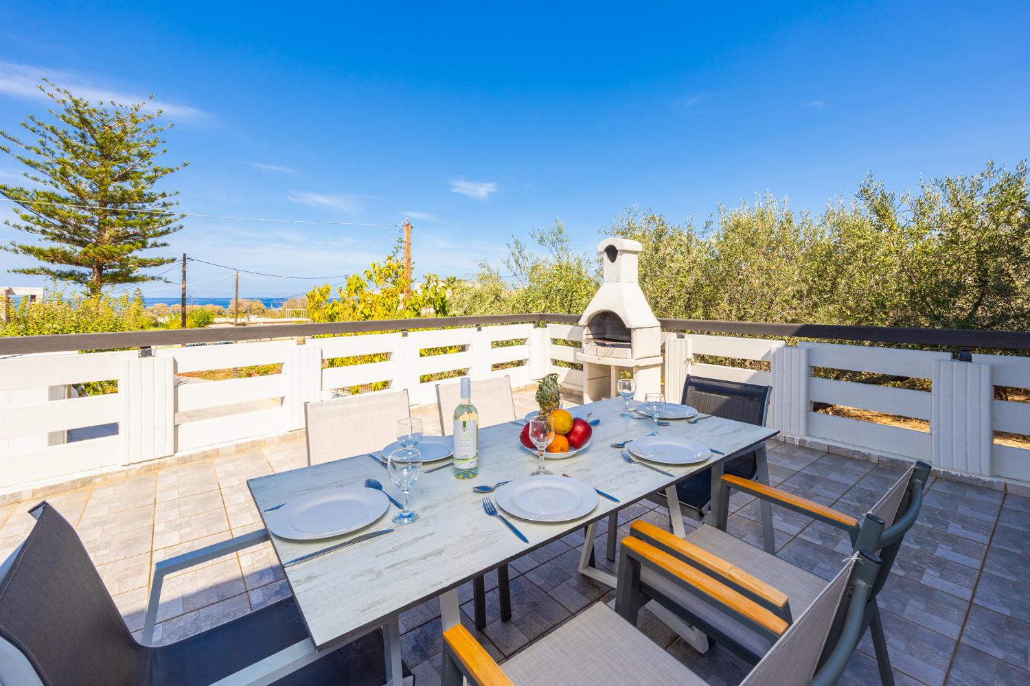 Sheltered terrace area with BBQ and sea views