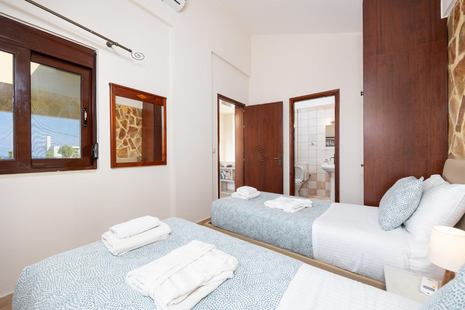 Twin bedroom with en suite bathroom and A/C