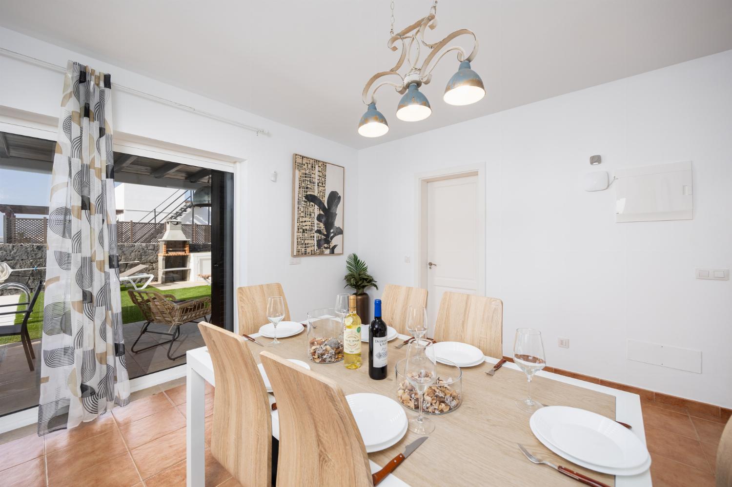 Living room with sofa, dining area, A/C, WiFi internet, and satellite TV