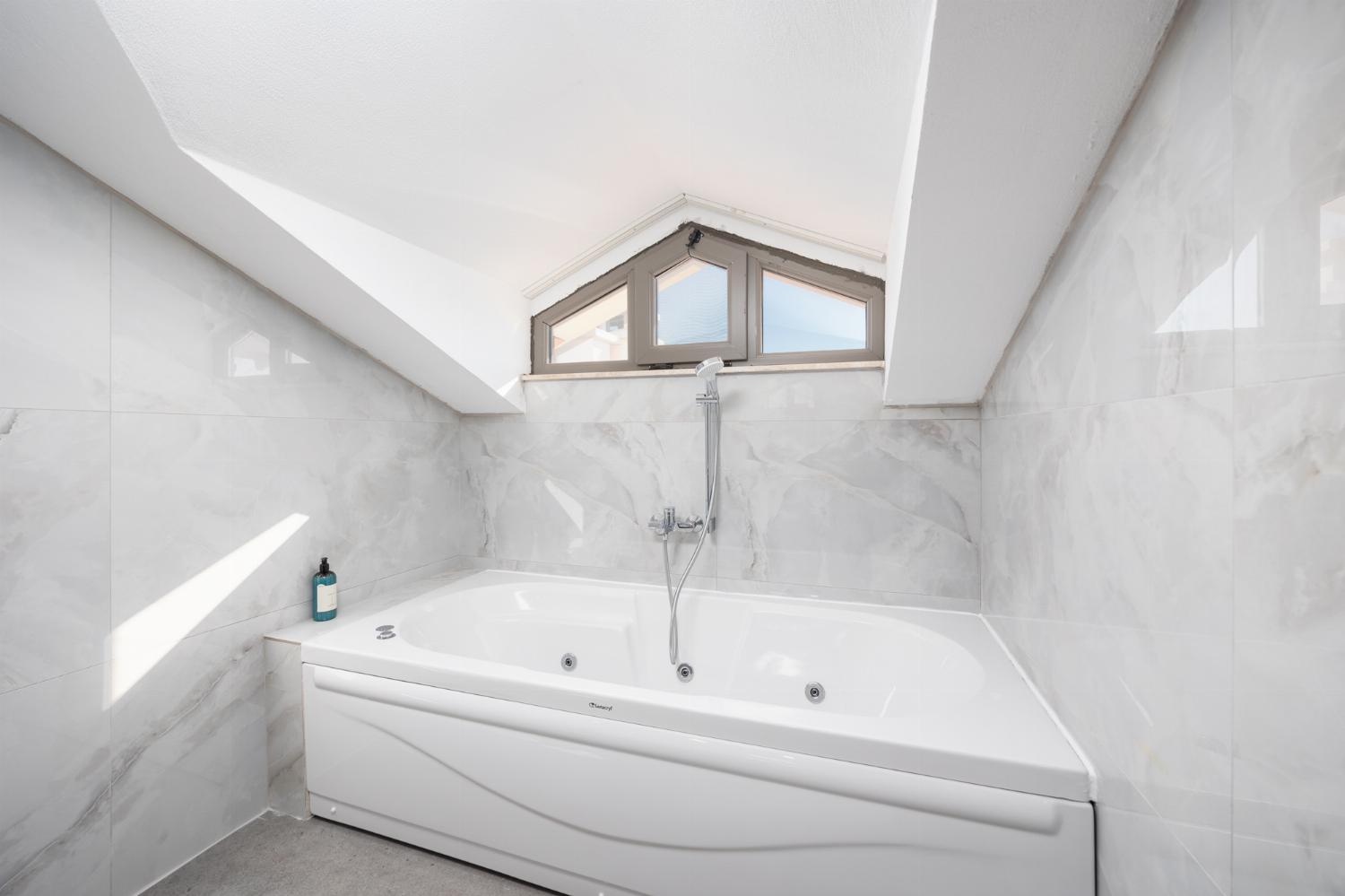 En suite bathroom with bath and shower