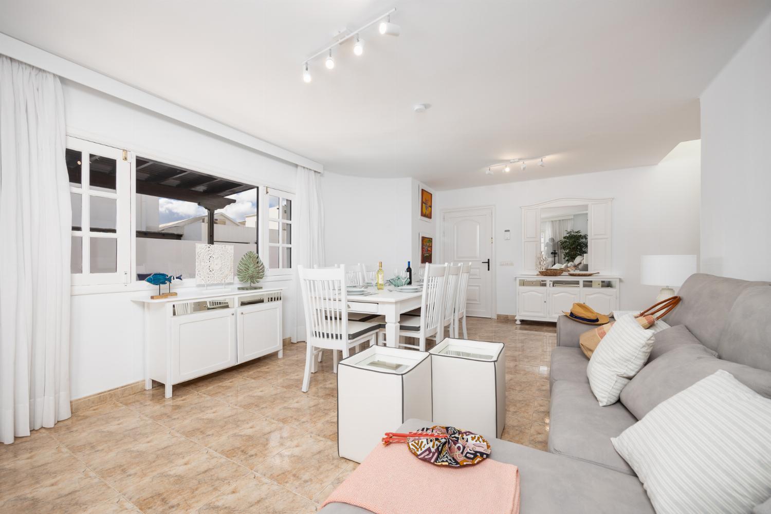 Living room with sofas, dining area, A/C, WiFi internet, and satellite TV